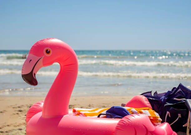 istock Giant inflatable pink flamingo pool float toy on the beach 1487058459