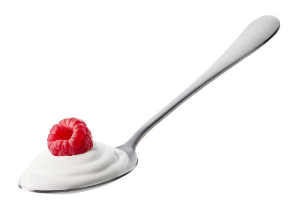 istock Spoon of fresh greek yogurt and raspberry on white background 1487060296