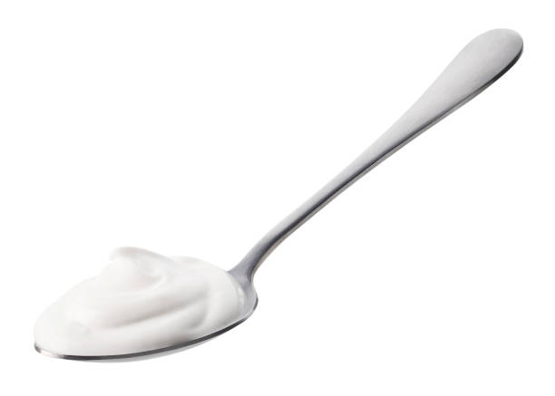 istock Spoon of fresh greek yogurt on white background 1487060305