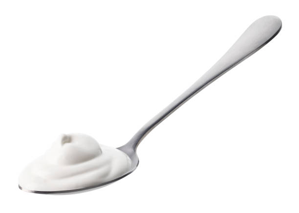 istock Spoon of fresh greek yogurt on white background 1487060308