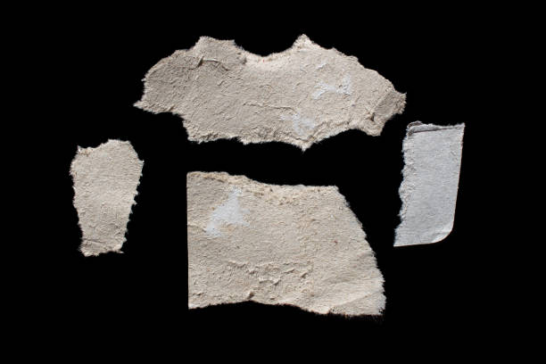 istock Ripped paper piece isolated on a black background 1487062481