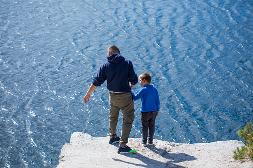 Happy family. Father playing with son  oudoors. Positive human emotions, feelings, joy on the lake  in Korostyshiv quarry, Zhytomyr district, northern Ukraine.