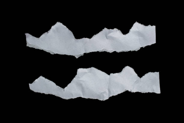 istock Ripped paper piece isolated on a black background 1487064672