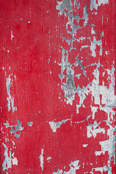 istock Red door with peeling paint and scratches texture 1487064908