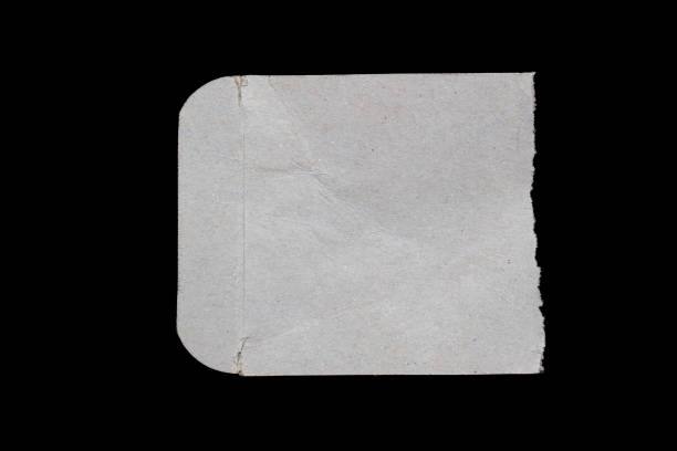 istock Ripped paper piece isolated on a black background 1487065323