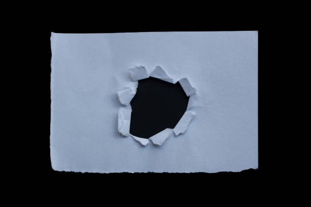 istock Ripped paper piece isolated on a black background 1487065659