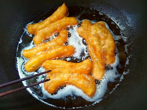 Cooking Deep fried Chinese Dough Sticks - food preparation.