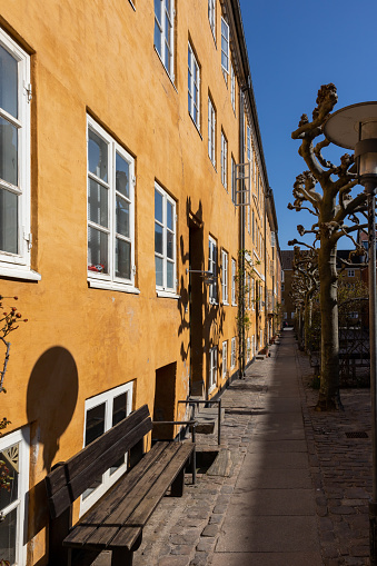 Warm lamplight illuminating the narrow alleyways leading the colourful townhouses and quaint restaurants of historic Stortorget, Great Square, the iconic landmark plaza on Gamla Stan in the heart of Stockholm, Sweden's vibrant capital city.