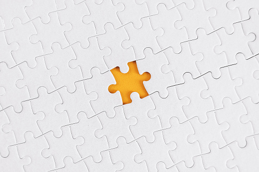 The Missing Piece.A jigsaw puzzle with a gap where one piece is missing.