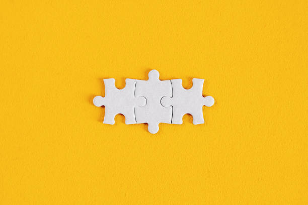 Matching Puzzle Pieces on Yellow Background stock photo