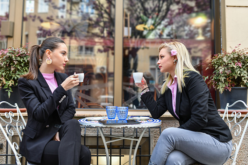 Gossiping Female Clerks Drinking Coffee In The Morning