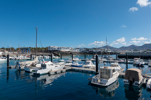 Playa Blanca, Yaiza, Lanzarote, Canary Islands, Spain - April 21, 2023: Panoramic view of the pretty port of Playa Blanca, in Yaiza, Lanzarote island, Spain.