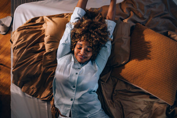 istock A Happy Beautiful Woman In Pajamas Stretching While Waking Up 1487069501