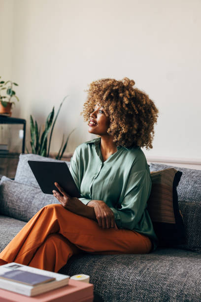 istock A Happy Beautiful Businesswoman Looking Away While Working From Home On Her Tablet 1487069573