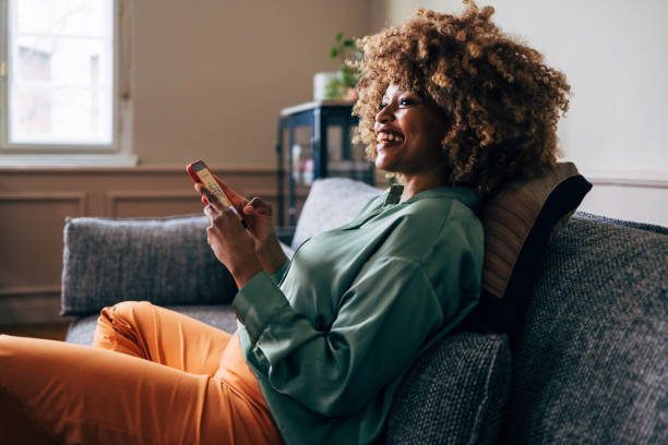 istock A Happy Beautiful Woman Looking Away With Excitement While Using Her Mobile Phone 1487069596