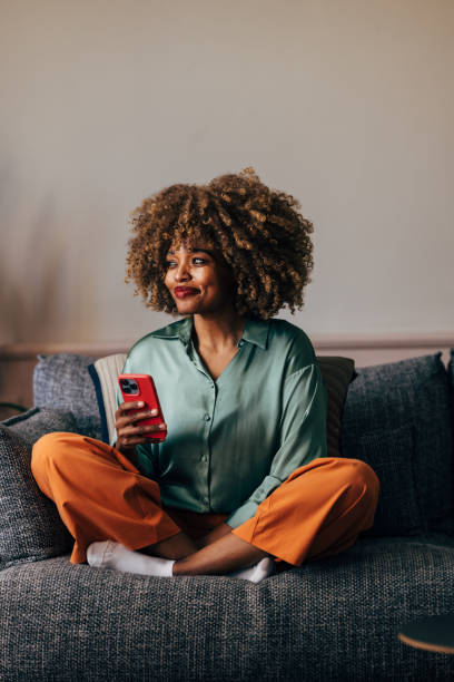 istock A Happy Beautiful Woman Looking Away While Using Her Mobile Phone 1487069603