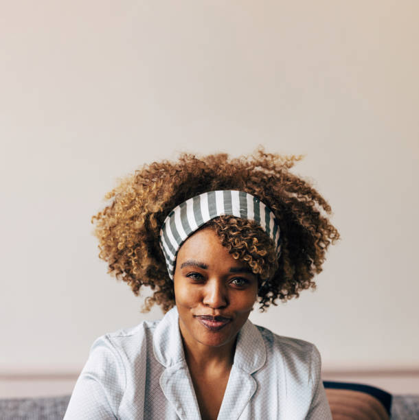 istock A Happy Beautiful Woman In Pajamas Looking At Camera While Relax 1487069625