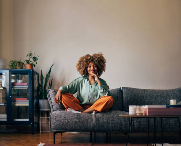 istock A Happy Beautiful Woman Looking At Camera While Relaxing At Home 1487069658