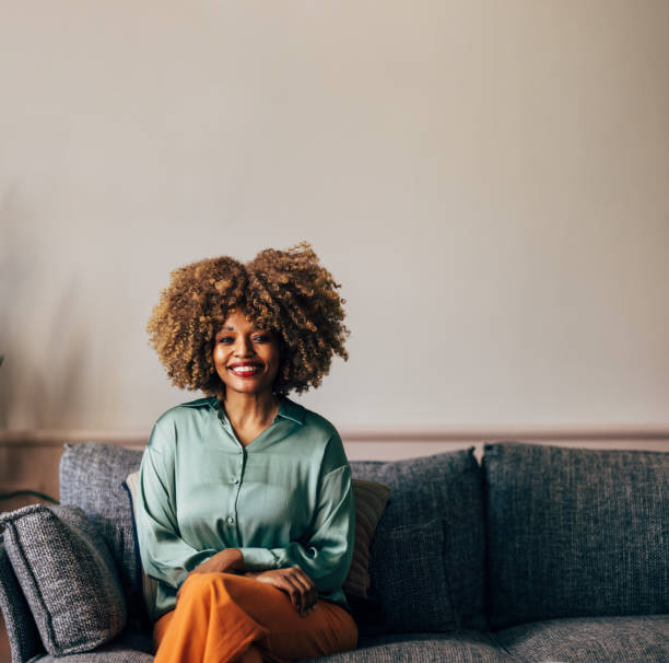 istock A Happy Beautiful Woman Looking At Camera While Relaxing At Home 1487069675