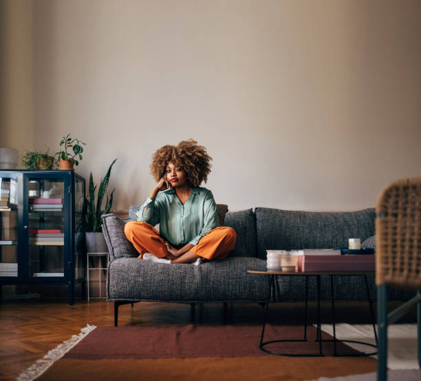 istock A Happy Beautiful Woman Looking At Camera While Relaxing At Home 1487069693
