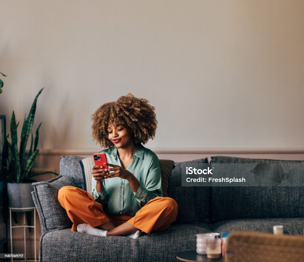 A Happy Beautiful Woman Texting On Her Mobile Phone While Relaxi - Royalty-free Mensen Stockfoto A Happy Beautiful Woman Texting On Her Mobile Phone While Relaxi - Royalty-free Mensen Stockfoto