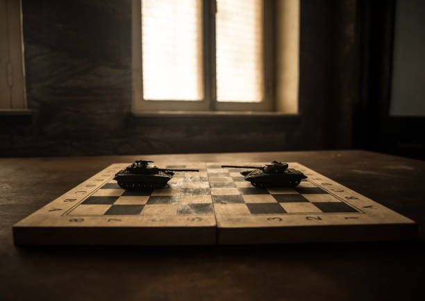 Conflict between Russia and Ukraine, conceptual image of war using chess board and tanks