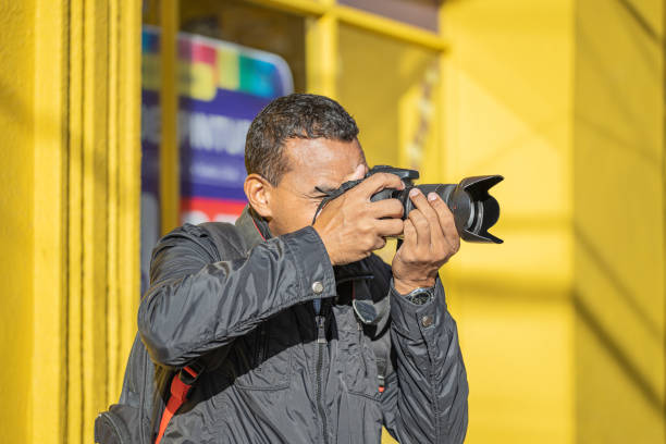 istock Latino photographer taking a picture with his camera. 1487071300