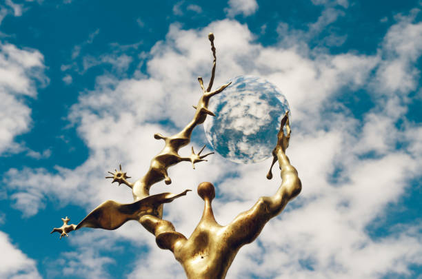 Figure holding a mirror with sky reflection, transparent glass sphere with sky distortion