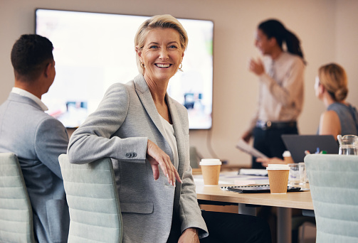 Business woman, portrait or leadership in office boardroom meeting, marketing workshop or advertising training goal. Smile, happy or mature corporate ceo in teamwork collaboration or diversity review