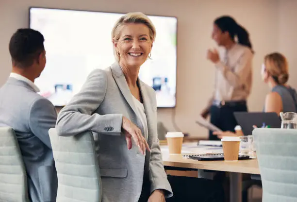 Photo of Business woman, portrait or leadership in office boardroom meeting, marketing workshop or advertising training goal. Smile, happy or mature corporate ceo in teamwork collaboration or review