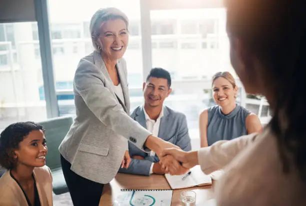 Photo of Ceo meeting, success or business people shaking hands after a contract agreement for working together. Diversity, company and happy management welcome a worker in a new partnership deal in office