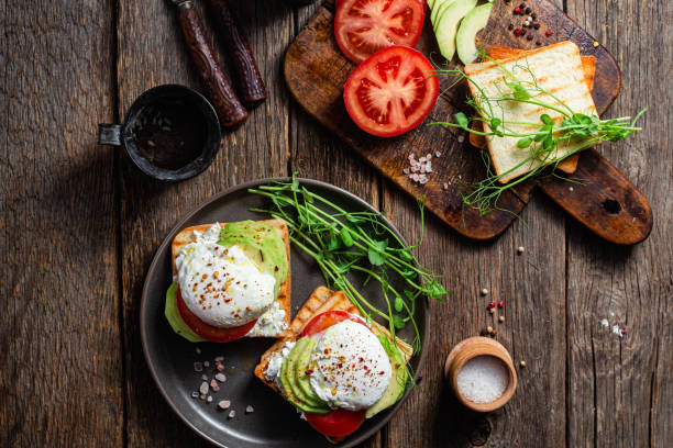 istock Toast with poached egg, tomatoes and avocado. Healthy breakfast 1487072984