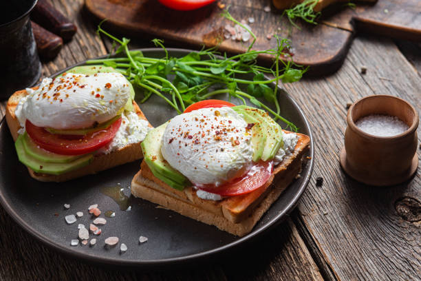 istock Toast with poached egg, tomatoes and avocado. Healthy breakfast 1487072987