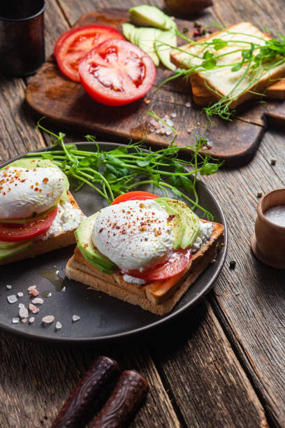 istock Toast with poached egg, tomatoes and avocado. Healthy breakfast 1487072995