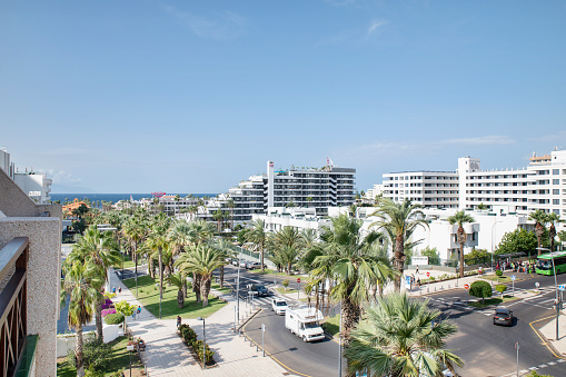 Playa de Las Americas, Tenerife, Canary Islands, Spain - December 30, 2022: ample views of the hotels lining up the coastal resort popular for beautiful beaches, watersports and a vibrant nightlife.