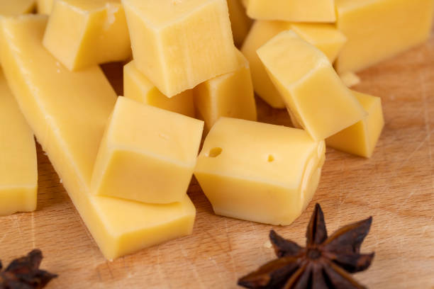 istock Yellow hard cheese sliced on a board 1487076325