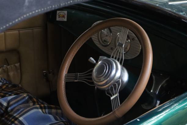 istock Classic car steering wheel featuring a wooden-like grip 1487077270
