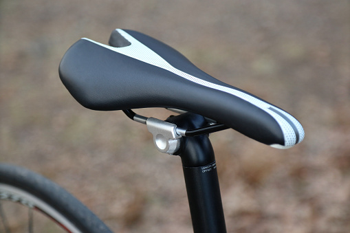 detail of bike saddle, seat, seatpost with bokeh narrow field of view black and white