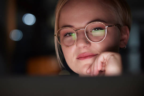 istock Night, office and woman with laptop reflection in her glasses while working overtime on a project. Technology, late and professional business female planning corporate report on computer in workplace 1487079907