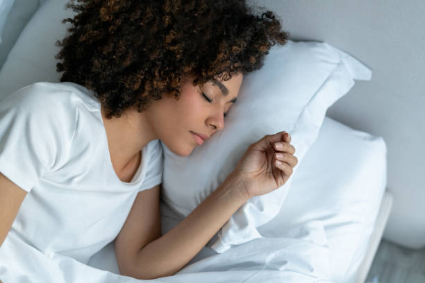 Young woman sleeping in her bed