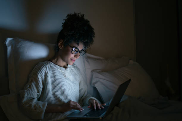 istock Woman working late at a home in bed and using her laptop 1487080822