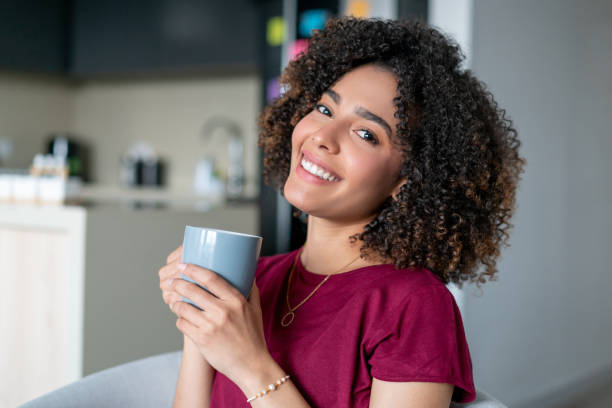 istock Happy woman at home drinking coffee and smiling 1487080831