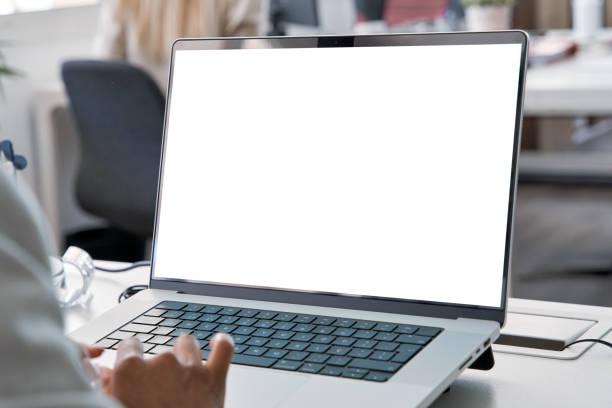 Young business woman working on laptop with blank copy space screen for ad app stock photo
