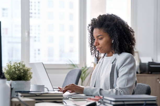 istock Middle age business woman working, browsing, and typing on touchscreen laptop. 1487082255