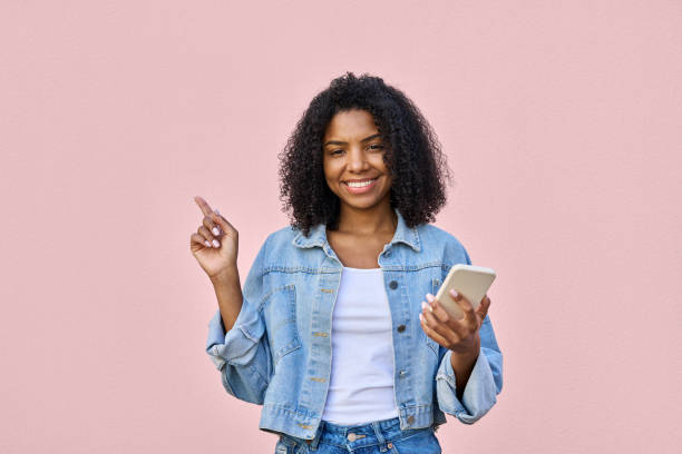 istock A woman showing a copy space for advertisement for mobile cell phone apps. 1487082270