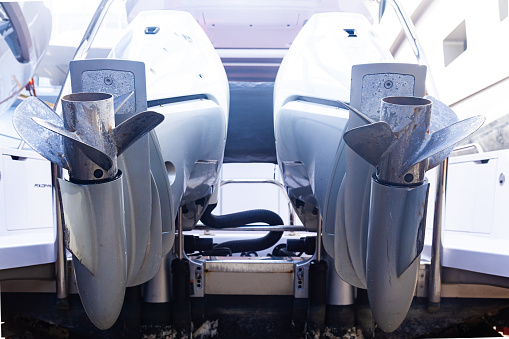 Motor propellers for motor yachts and boats close-up. The motors are installed at the stern of the boat. The outboard motors at the stern of the boat are raised.