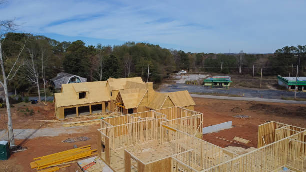 istock Two houses under construction with building envelope and wooden frame beam, joist, trusses framework, gable roof in suburban area of Flowery Branch, Georgia, USA 1487084022