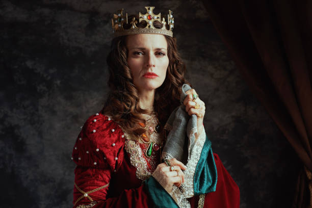 istock medieval queen in red dress with handkerchief and crown 1487084900