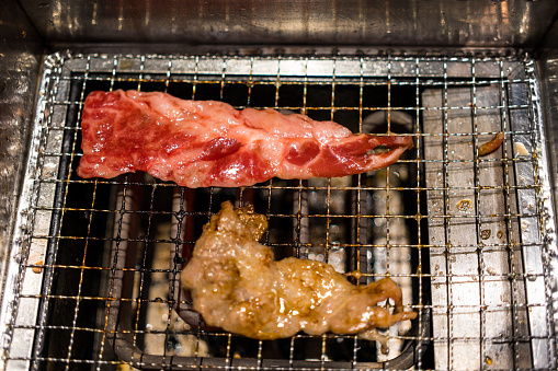Japanese grilled meat over charcoal on the stove. Close up