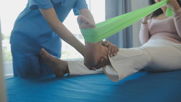 istock young asian physical therapist working with senior woman on walking with a walker 1487087699
